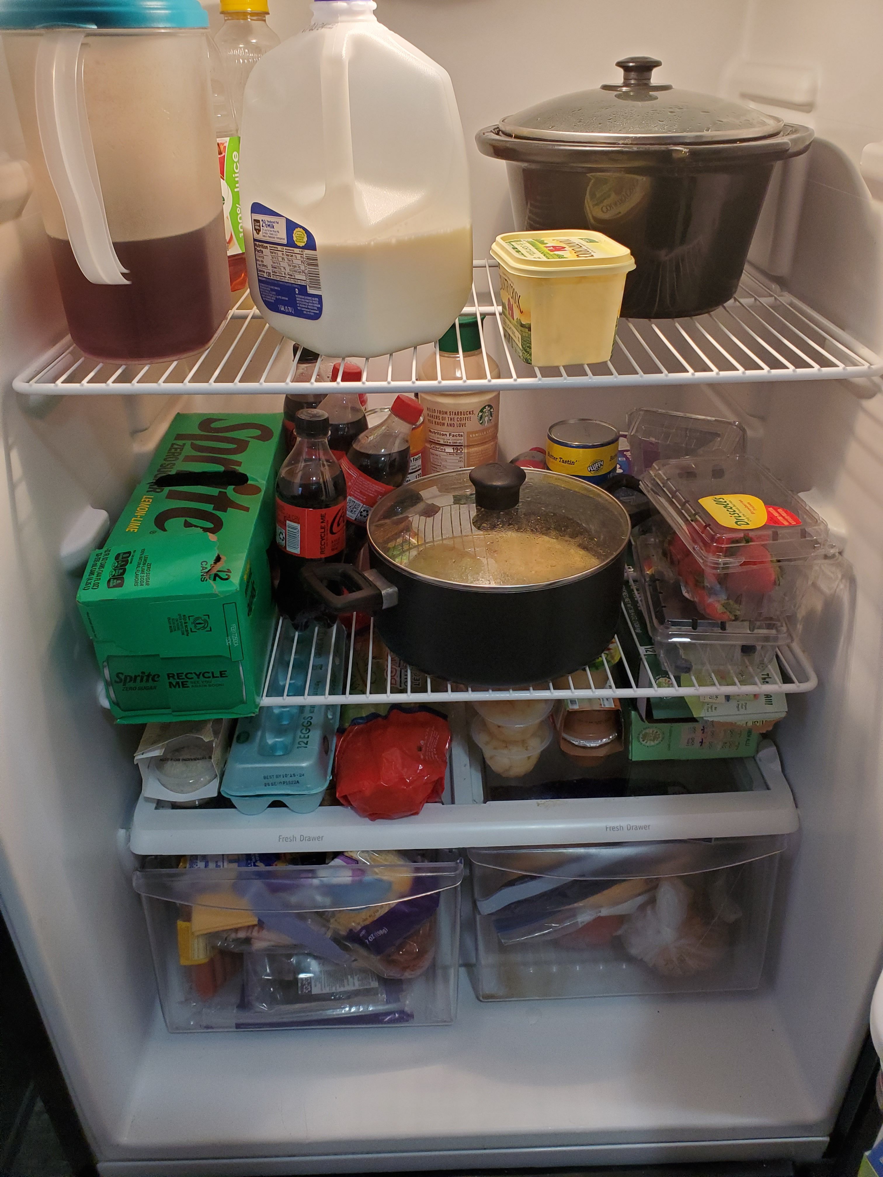 Inside of fridge with various ingredients. 